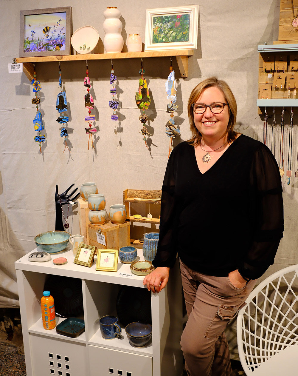 Amy Dooley, owner of Studio 89, stands beside her pottery works that are part of this month’s Holiday Show.
